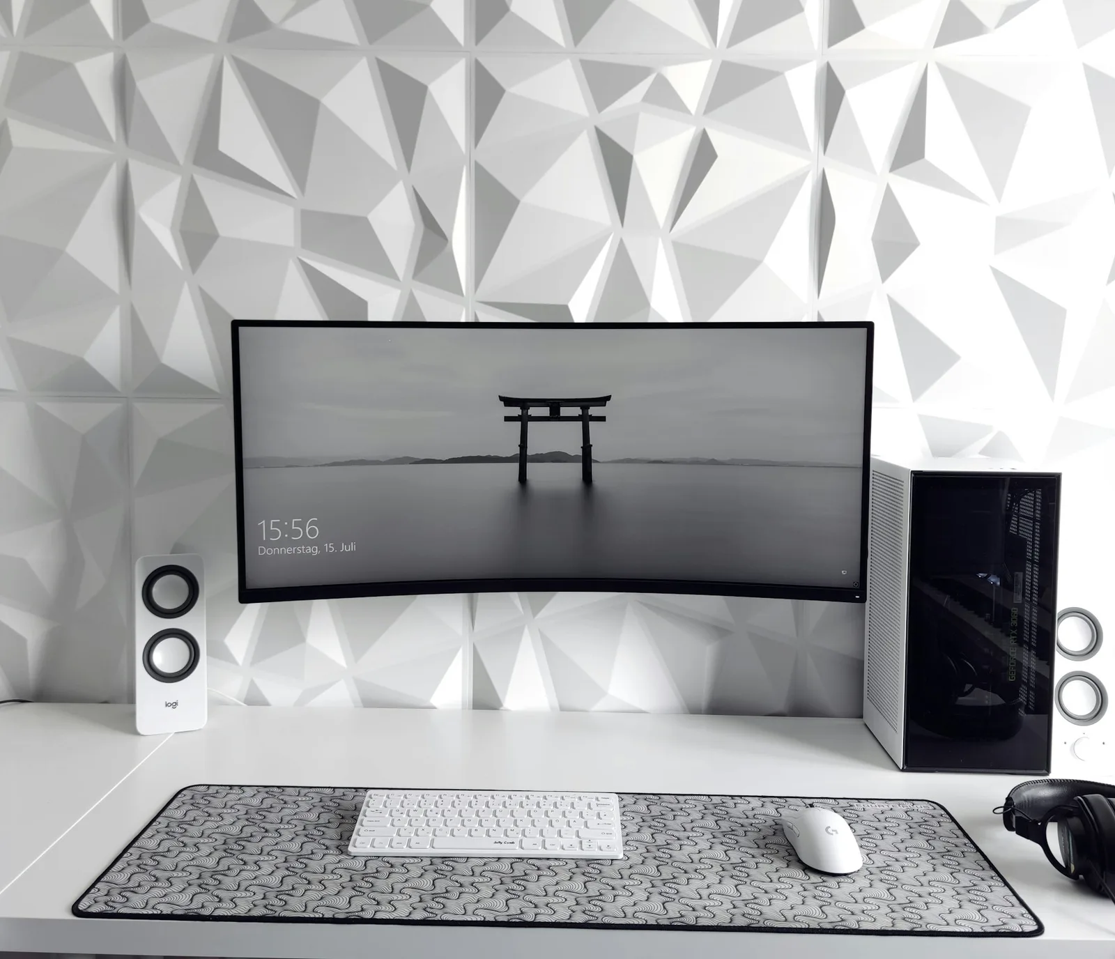 Ultrawide monitor and speakers on a desktop workstation